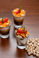 Bifum salad with chickpeas Delicious appetizers in shot glasses with fresh ingredients