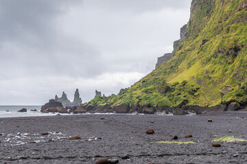 Plage de sable noir de Víkurfjara, avec les aiguilles basaltiques de Reynisdrangar au loin, à Vík í Mýrdal, dans le sud de l'Islande