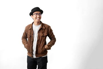 Studio portrait of a smiling man in brown jacket, striped tee, hat and glasses on white copy space—clean, modern look for branding, ads, fashion or lifestyle content.