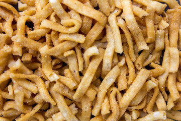 Golden crispy chips with crunchy texture salty tasty snack food as background