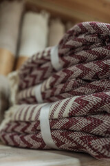 Fototapeta premium Stacked burgundy and white patterned towels