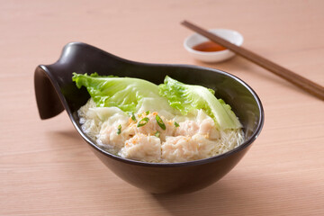 A bowl of Wonton noodles and chopsticks