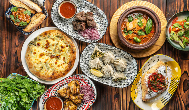Traditional Georgian cuisine assortment with khinkali, khachapuri, and meat dishes