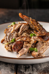 Juicy pulled pork with crispy crust and herbs