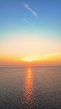 Aerial drone footage of sunrise above Bristol Channel as seen from Penarth. Vertical slow pull out shot.