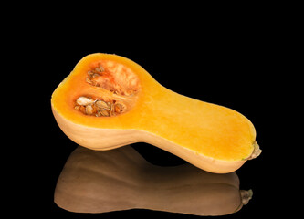 Ripe sweet pumpkins isolated on black background, close-up.