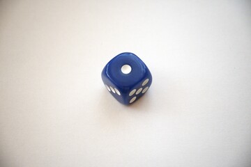 Single blue die showing one pip, isolated with copy space for design use.