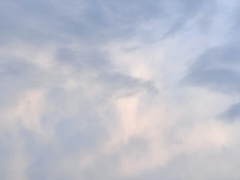 Soft Stratus And Stratocumulus Clouds in Pale Blue Sky