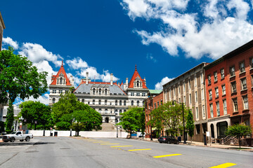 Street view of the historic New York State Capitol building, an architectural landmark in Albany USA, on a bright sunny day with a blue sky