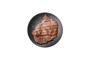 Grilled beef steak, meat cooked on barbecue with salt and pepper. Grilled beef steak