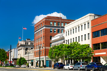 View of Pittsfield's historic downtown in Massachusetts, featuring brick and stone commercial buildings lining tree-framed North street