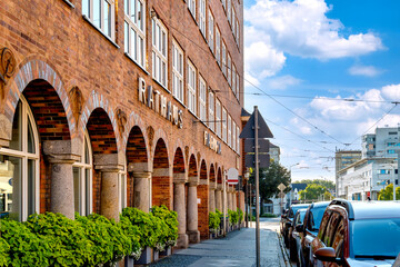 Obraz premium Cottbus, Brandenburg – Town hall building -Rathaus- with distinctive architecture and flowering potted plants in city center