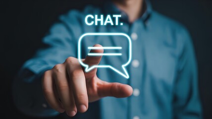 Hand pointing forward, fingertip touching glowing holographic chat bubble icon outlined in cyan light with floating CHAT text, futuristic communication, messaging, and digital interaction concept