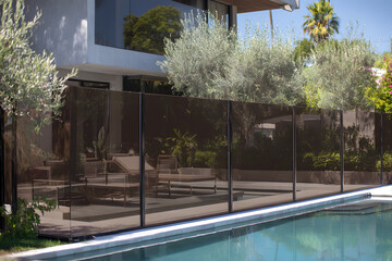 Pool area separated by dark glass panels for privacy and modern zoning. architectural and design solution. 