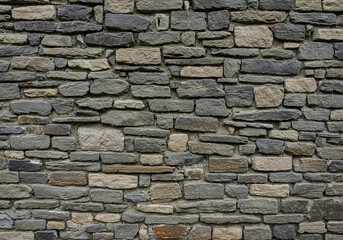Obraz premium Rough textured stone wall offers rustic charm and enduring strength for natural backgrounds