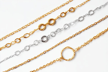 Arranging various gold and silver chains on a pristine white surface creates a stunning visual display of jewelry, highlighting elegance and luxury in a captivating manner