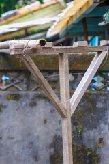A handmade wooden clothes drying rack stands outdoors at Xian Guang Military Kindred Village Cultural Park in Taoyuan City, Taiwan, reflecting local craftsmanship.