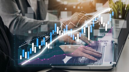 Business professionals engage in financial analysis with a laptop, focusing on dynamic graphs and...