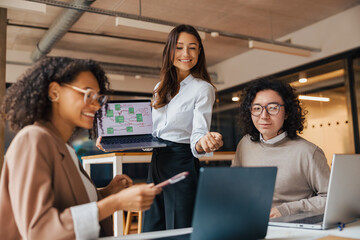 A diverse team of skilled professionals is collaborating on an innovative project in a stylish office setting