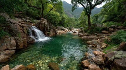 Serene river flows through rocky landscape with small waterfall cascading into tranquil pool,