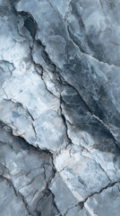 An abstract shot of a textured stone surface showing detail of cracks and lines