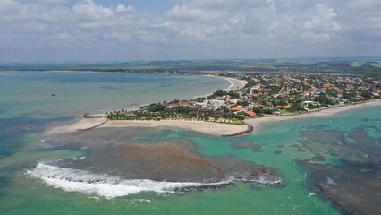 Fantastic panoramic view of Serrambi beach with coral reefs, natural swimming pools in the sea, white sand and palm trees. Serrambi near Recife in Pernambuco State, Brazil 