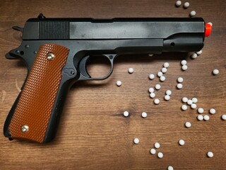 Airsoft Gun with White BBs. Though only an airsoft replica, the photo highlights the weapon’s...