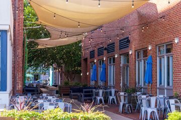 An outside dining area with tables and chairs along the Patapsco River in Baltimore Maryland USA
