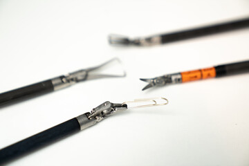 Fishing tackle equipment on a white surface ready for use. Different fishing tackle tools are arranged on a white surface, ready for fishing activities and preparation.