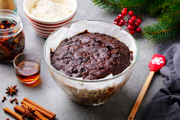 Christmas fruit cake, pudding in baking dish. Traditional festive dessert. Grey background. Close up.