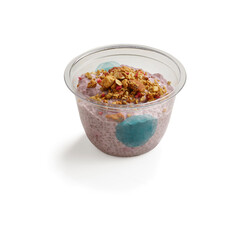 Berry chia seed pudding with granola topping in clear container