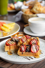 variety of breakfast items, breads, eggs, waffles, cereals, and cheeses