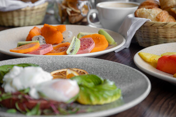 variety of breakfast items, breads, eggs, waffles, cereals, and cheeses
