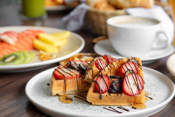 variety of breakfast items, breads, eggs, waffles, cereals, and cheeses