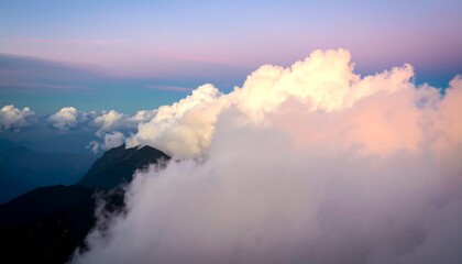 Obraz premium Mountain peaks peeking through clouds at dawn