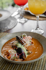 Cream of clam soup served with rice and fried plantains