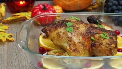 a woman is preparing a festive dinner at home. chicken with oranges. On the table there is pie and fruits, grapes, apples, pumpkin. Roasted Turkey. Thanksgiving table served . Christmas dinner