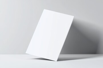 Blank white card tilted on a light gray surface.