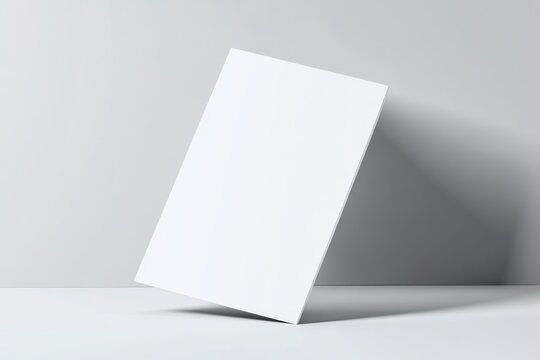 Blank white card tilted on a light gray surface.