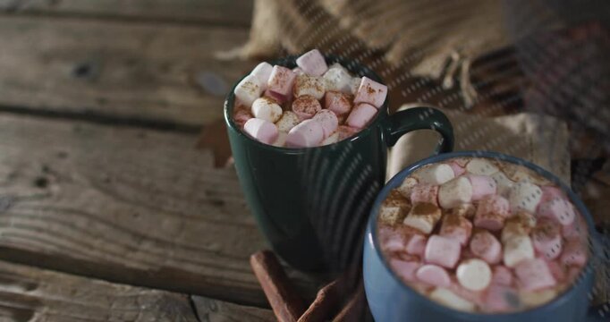 After shot, overlay drifting across mugs showing marshmallow detail before receding to restore view