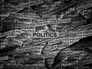 Strips of newspaper with the words Politics typed on them. Black and white. Close up.