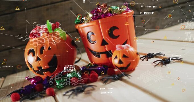 After pause digital overlay hexagons floating and swirling over pumpkins, visualizing candy data