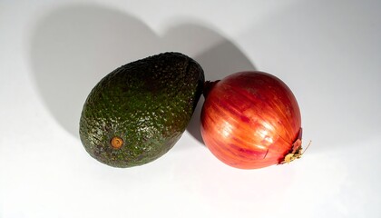 Two whole fruits, an avocado and an onion, on white background