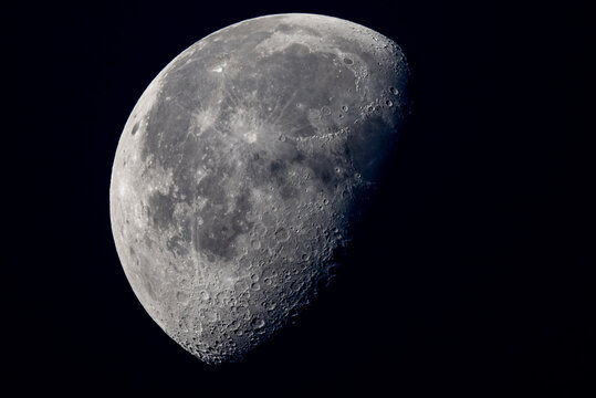 half moon on black background with crater detail