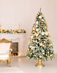 Elegant Christmas tree in a light-filled room with gold ornaments and cream accents
