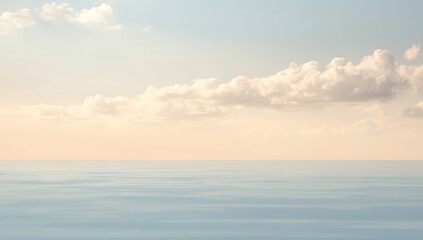 Fototapeta premium Beautiful orange clouds drift across the evening sky as the sun sets over the calm ocean horizon