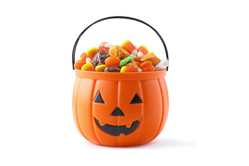 An orange halloween pumpkin bucket, carved with a smiling face, is overflowing with a colorful assortment of candies and treats isolated on transparent background
