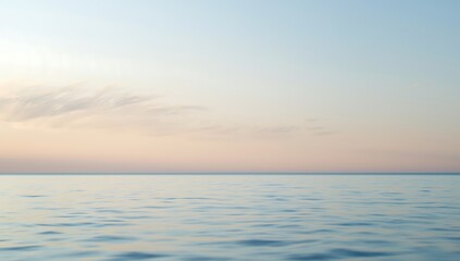 Obraz premium The beautiful summer sunset over the ocean horizon where the sun's light creates a reflection on the sea waves under a cloudy sky