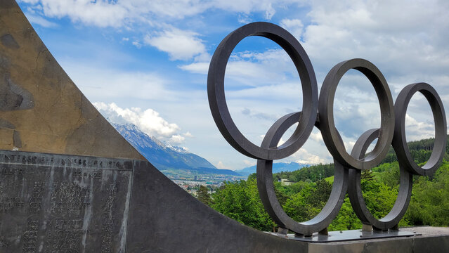 View of Innsbruck from the Olympic Park at Bergisel Hill. In the foreground - the Olympic rings. May 19, 2023. Innsbruck, Austria.