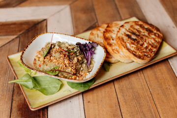Savory dish with toast on wooden board. Pâté, puree or foie gras serving.